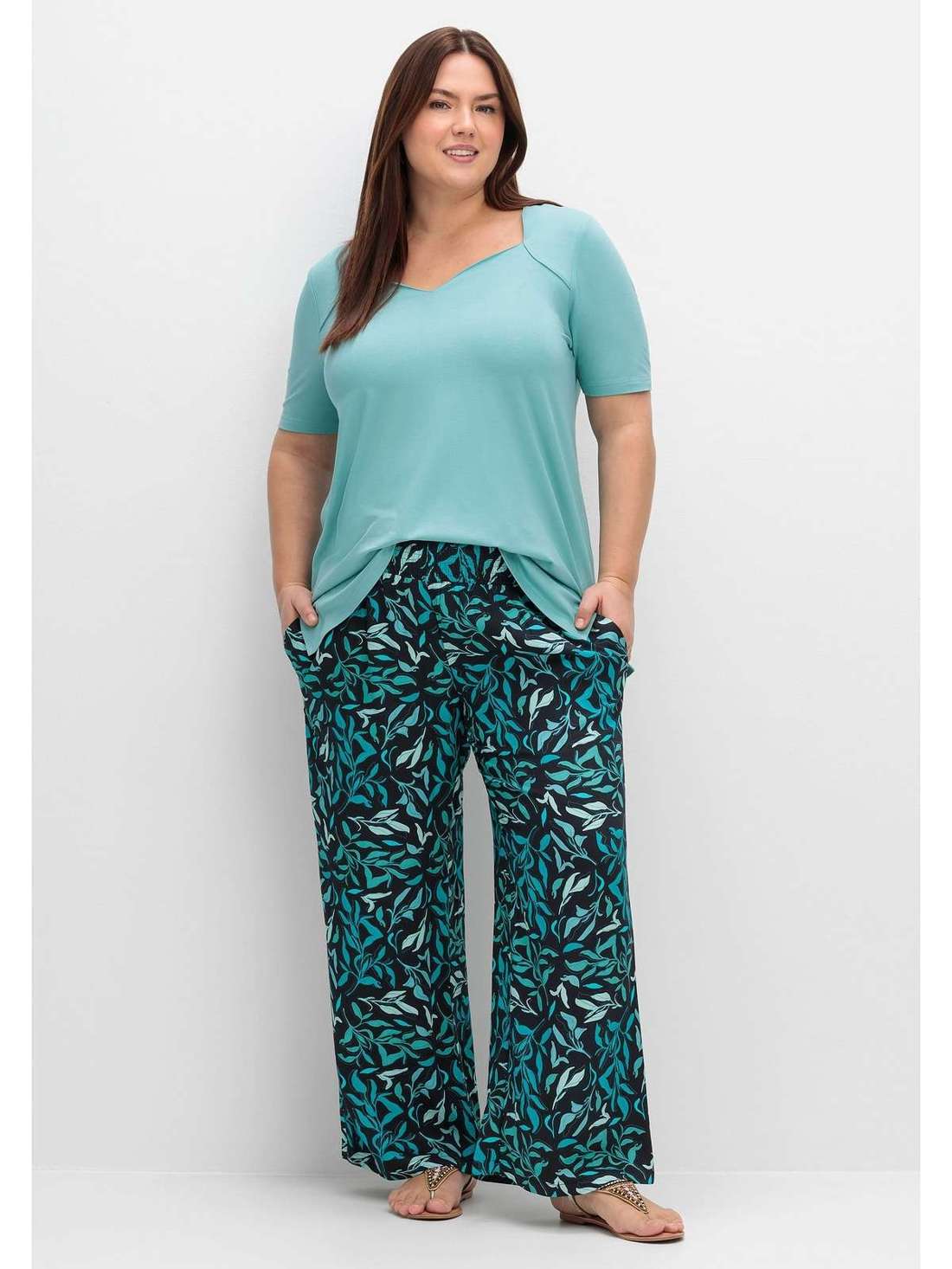 Брюки без застежки с присборенным поясом и принтом в виде листьев. Große Größen