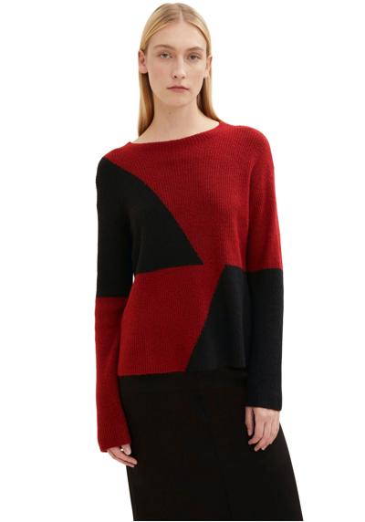 Вязаный свитер с двухцветным геометрическим узором.