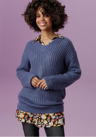 Длинный свитер с фиксированными манжетами на длинных рукавах.